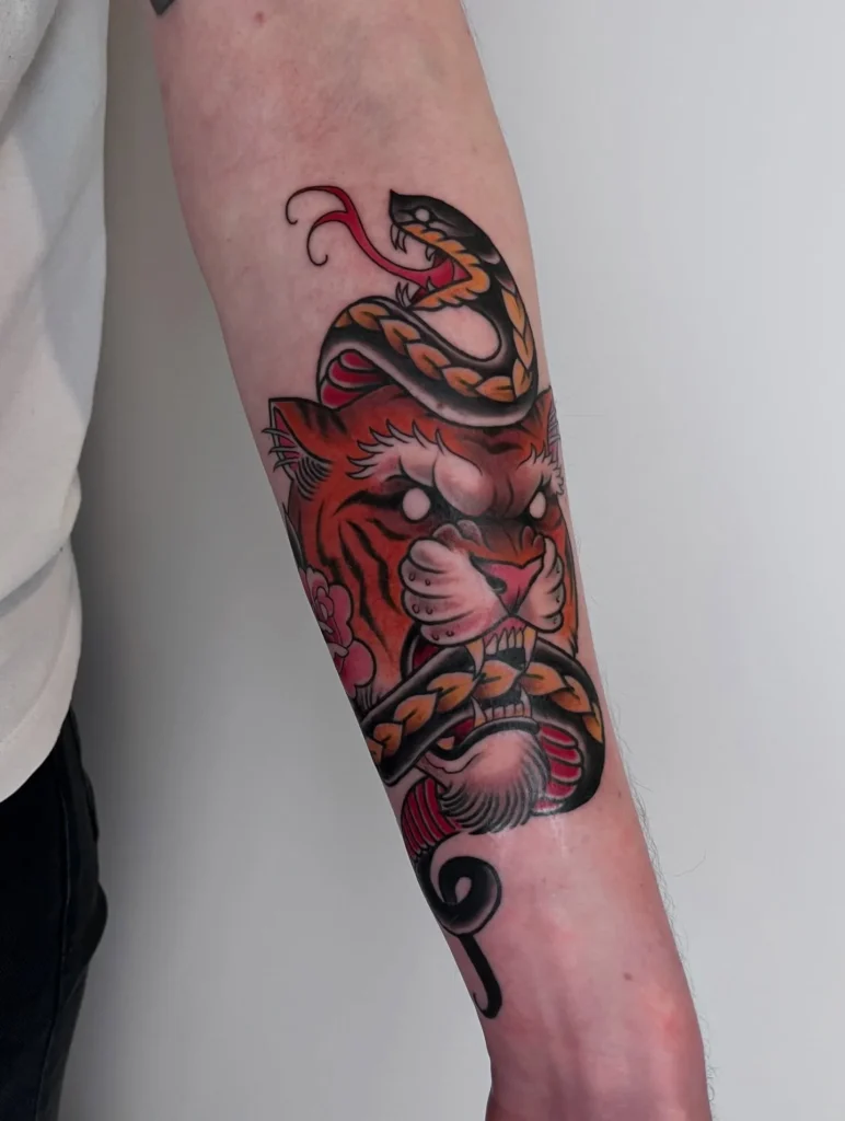 The Classic Tiger and Serpent Duel Tattoo