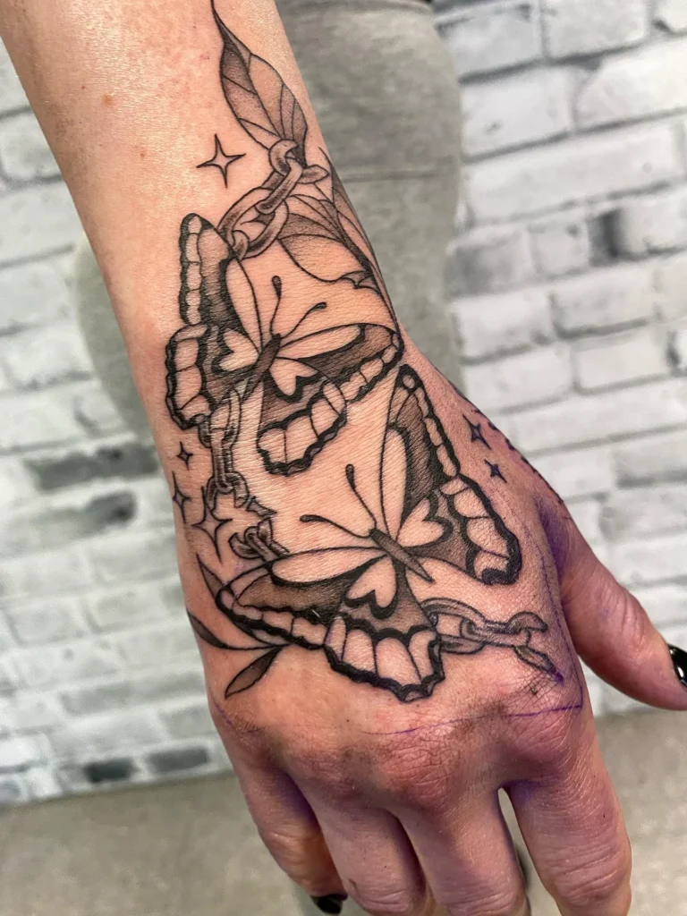 Butterflies and Broken Chain Hand Tattoo
