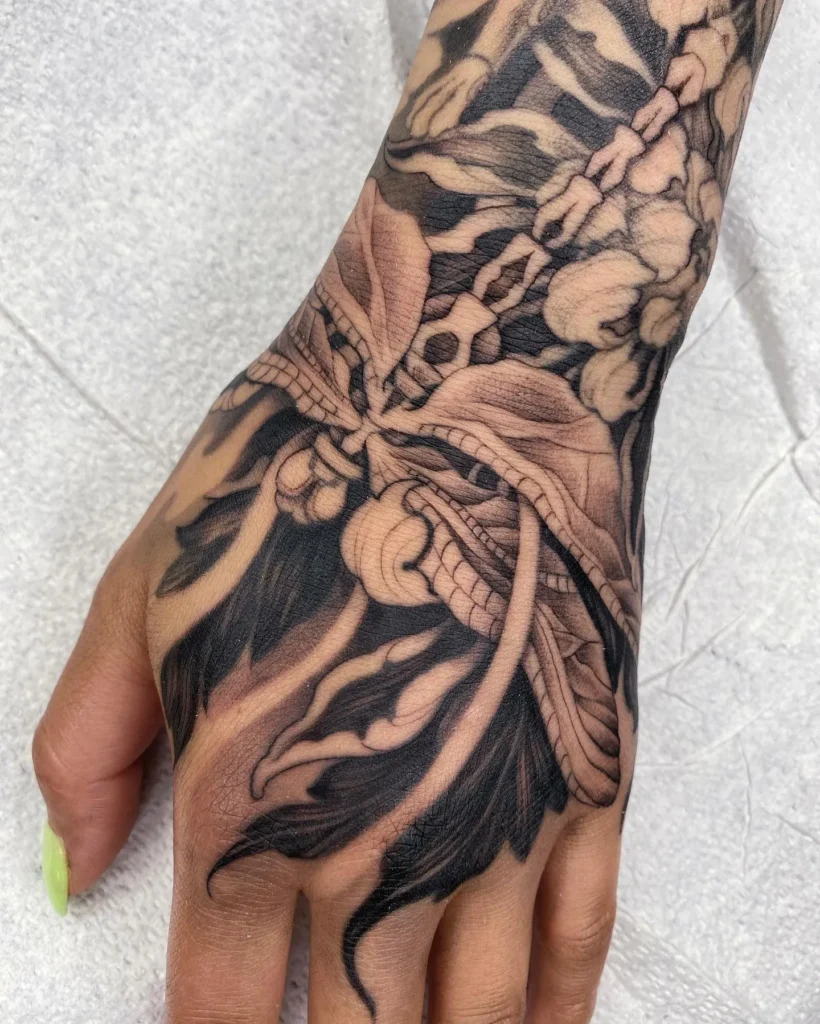 Dragonfly and Botanical Flow Hand Tattoo