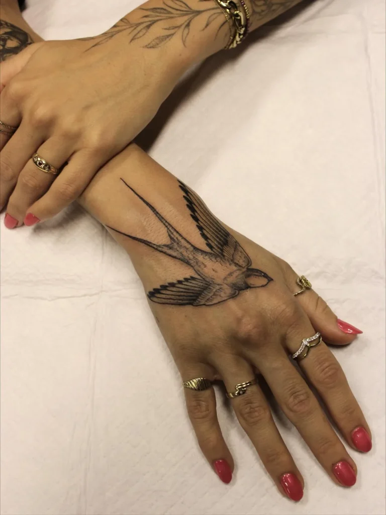 Fine Line Soaring Swallow Hand Tattoo